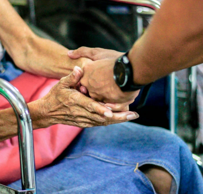 man holding hand with woman on chair